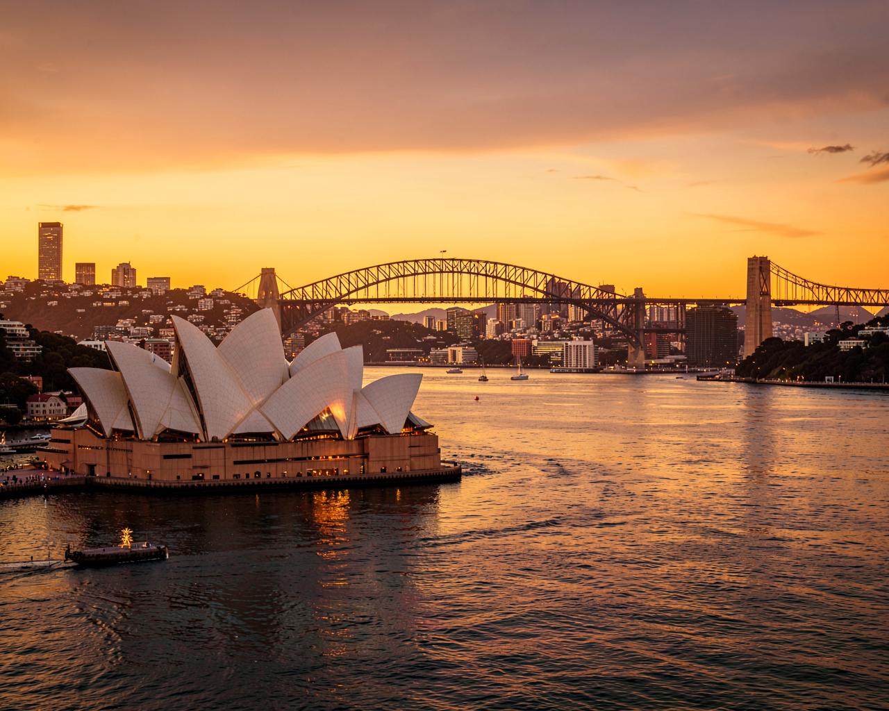 Sydney Harbour at dusk — the Opera House and Harbour Bridge, home of 5cap